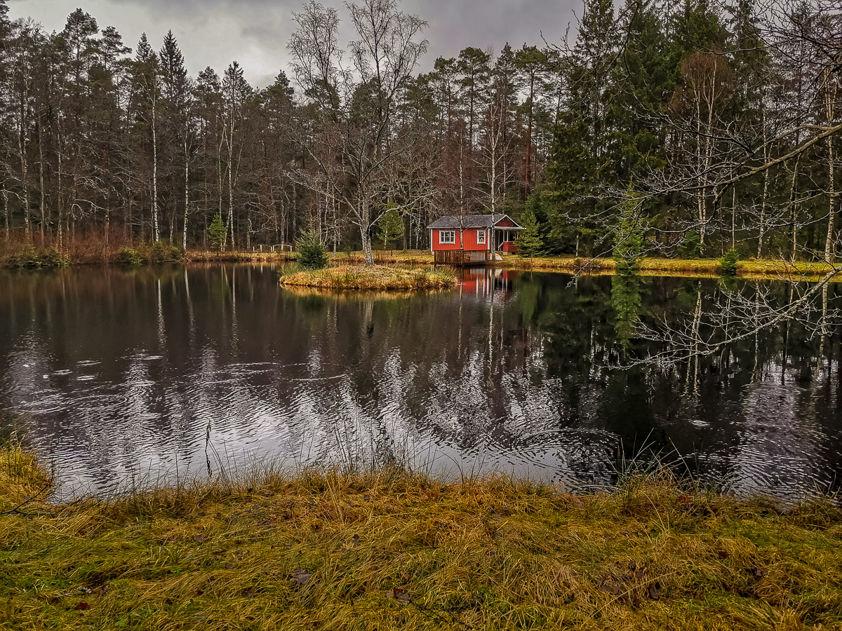 Kleines rotes Haus mit See laden zum Fischen und Baden